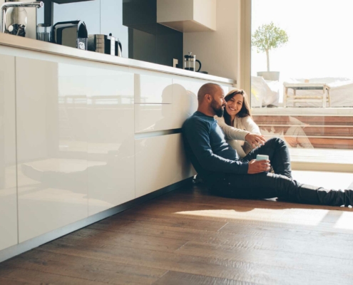 Couple on the floor in kitchen after new home purchase